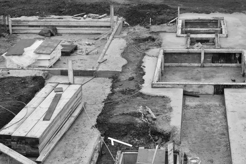 Vista aérea de fundações de concreto em canteiro de obras, mostrando a área total coberta pelas lajes